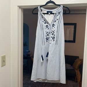 Preppy blue pin striped dress with embroidered patterns and fringe straps.